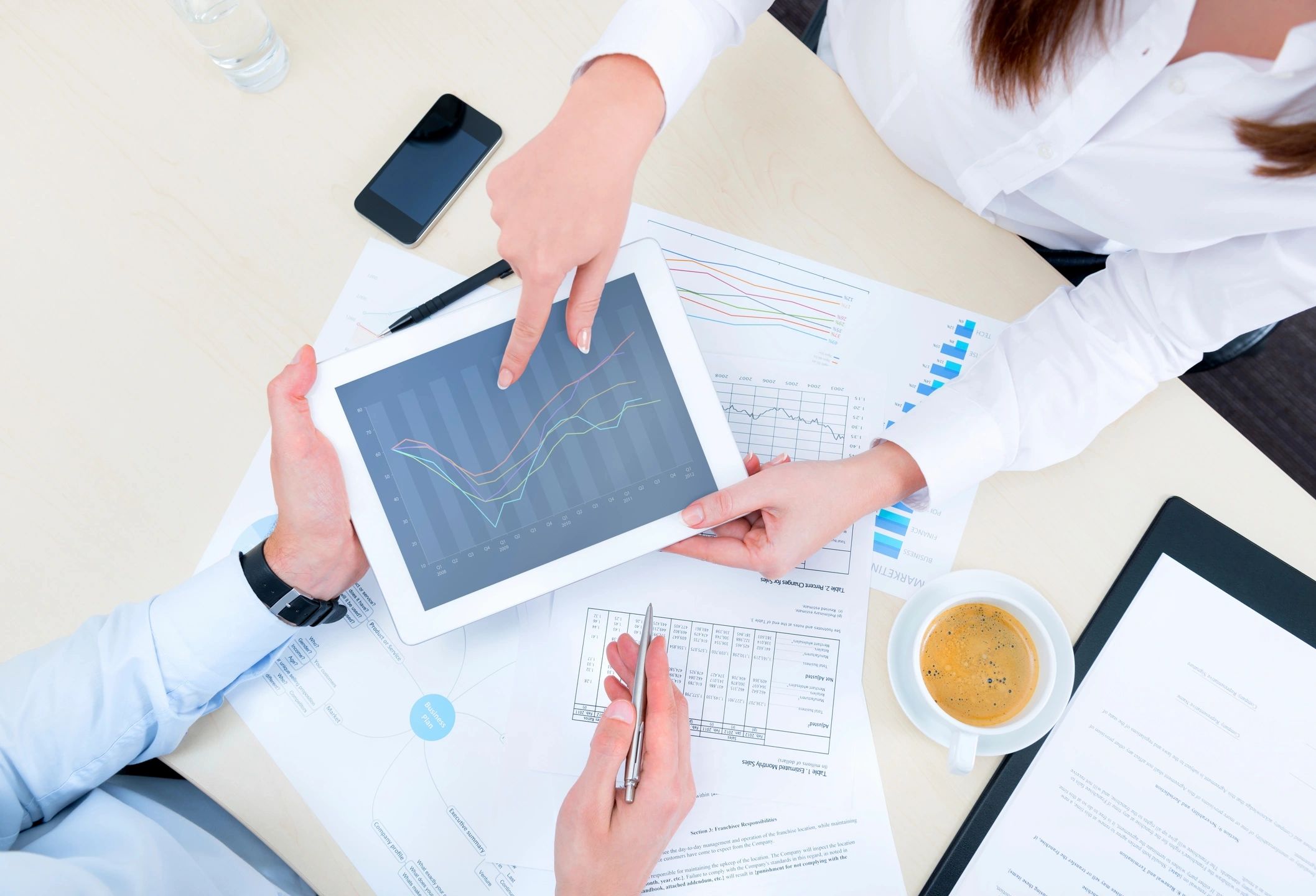 hands holding a tablet with data